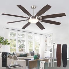 a ceiling fan in a living room with white walls