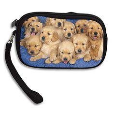 a group of puppies laying on top of a blue blanket under a zippered pouch