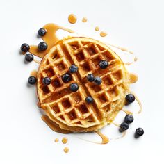 a waffle topped with blueberries and syrup