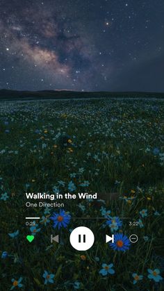 an iphone screen with the words walking in the wind on it, and blue flowers