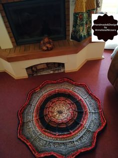 a living room with a fire place and rug on the floor