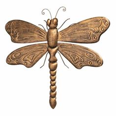 a wooden dragonfly sitting on top of a white background