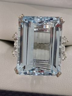 Absolutely stunning pre owned genuine Aquamarine and diamond ring. This ring makes a gorgeous engagement ring or cocktail ring. The ring is set with one huge Aquamarine measuring 15x20x9mm and .20mm deep. The center stone is apprx 17.26 carat Aquamarine. Also set are 14 melee accent diamonds total .78 ctw.   Have an appraisal estimated retail value $6200 14K white gold 12.8 grams size- Apprx 5.50-5.75 Pls note the ring shank is a wide flat shoulder and tapering square shank. This ring is pre owned and in good condition. Pls ask any questions before any bids. Comes w appraisal. Ring Shank, Gorgeous Engagement Ring, Cocktail Ring, Cocktail Rings, Aquamarine, Diamond Ring, Jewelry Watches, Engagement Ring, Jewelry Rings