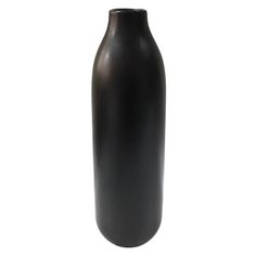 a black vase sitting on top of a white table