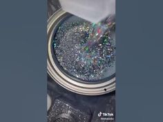 someone is pouring glitter into a can with the lid open and it's inside