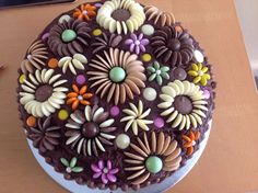 a chocolate cake decorated with flowers and candy