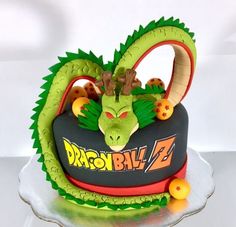 a birthday cake with a dragon on it's head and the words dragon ball z