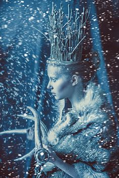 a woman with a crown on her head in the snow