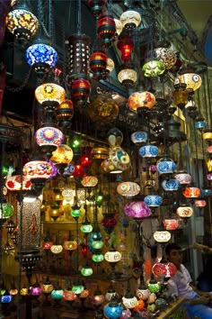 many colorful lights are hanging from the ceiling