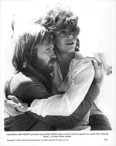 black and white photograph of two people hugging each other