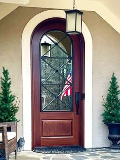 the front door is decorated with christmas trees