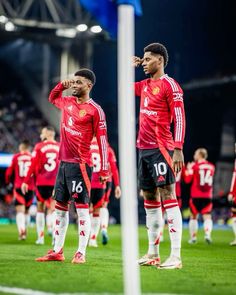 the soccer players are standing on the field