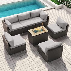 an outdoor patio furniture set next to a swimming pool