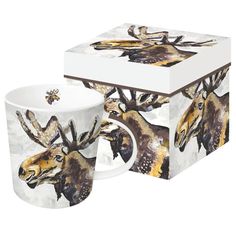 two coffee mugs sitting next to each other in front of a box with an image of moose on it