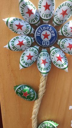 a bunch of beer bottle caps are attached to a wooden board with jumbo stickers