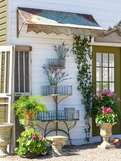 a house with potted plants and an umbrella