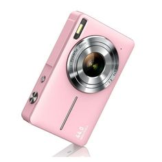 a pink digital camera sitting on top of a white surface with its lens up in the air