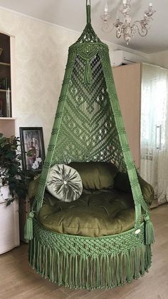 a green hammock hanging from the ceiling