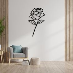 a living room with a chair and a clock on the wall that has a rose in it