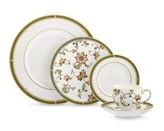 a white and gold dinner set with flowers on it