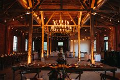 an indoor wedding venue with chandeliers and tables set up for the guests to eat