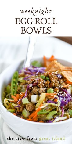 a white bowl filled with vegetables and meat on top of a table next to tortilla chips