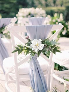 white chairs with blue sashes and flowers on them