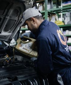 a man working on an engine in a garage