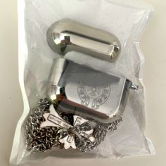 a silver lighter and chain in a plastic bag