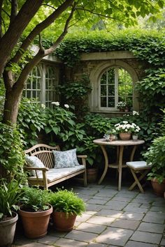 an outdoor patio with potted plants and tables in the center, surrounded by greenery