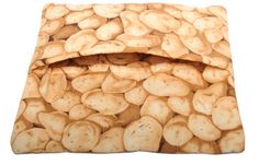 a pile of potato chips sitting on top of a bed