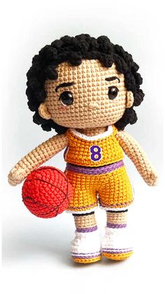 a crocheted doll holding a basketball ball