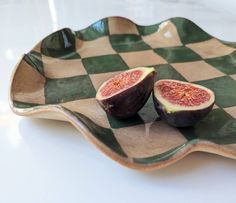 two figs are sitting on a checkered plate