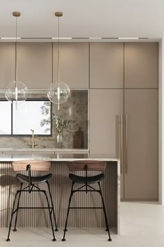 two stools sit in front of an island with marble countertops and pendant lights