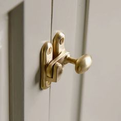 a close up of a door handle on a white door