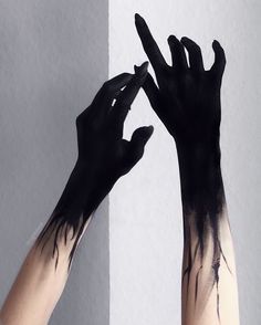 two hands that are painted black and white