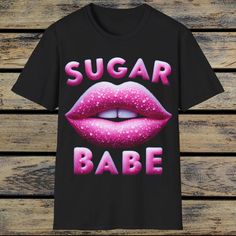 Sugar Babe T-Shirt,Pink Lips T-Shirt,Pink Lipstick Shirt,Girly Fashion,Lip Graphic Shirt,Trendy Pink Shirt,Lip Print Top,Cute Style Tee. The unisex soft-style t-shirt puts a new spin on casual comfort. Made from very soft materials, this tee is 100% cotton for solid colors. Heather colors and sports grey include polyester. The shoulders have twill tape for improved durability. There are no side seams. The collar is made with ribbed knitting to prevent curling damage.  .: Made with 100% ring-spun Funny Pink T-shirt With Text Print, Cute Pink T-shirt With Graphic Print, Pink Slogan T-shirt With Short Sleeves, Cute Pink T-shirt With Text Print, Trendy Pink T-shirt With Text Print, Pink Slogan T-shirt For Streetwear, Trendy Pink T-shirt With Screen Print, Trendy Pink Top With Sublimation Print, Cute Pink T-shirt With Funny Print