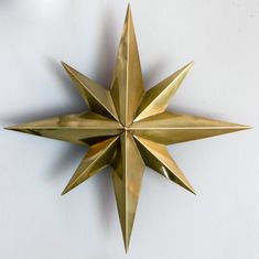 a gold metal star hanging on the wall