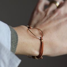 This simple and geometric boho bracelet is a great relaxed staple piece. It looks great on it's own or layered with so many different styles that the possibilities are endless. Each bracelet has a heavy duty hammered open oval in sterling silver or 14k gold fill, as well as a beautiful handmade clasp. This bohemian minimalist piece has classic relaxed elegance that looks killer with jeans, bold prints, and chunky sweaters. 100% of the profits from this design are currently (as of 10/9/18) being donated to Emily's List to support women running in the mid-term elections. If you aren't yet registered to vote, or if you aren't sure, click here to find out how to get registered. Be a voter! Available in dark chocolate or caramel brown round leather cord or on brown suede flat lace Metal options Embroidery Floss Bracelets, Floss Bracelets, Mid Term, Chunky Sweaters, Relaxed Elegance, Leather Cord Bracelets, Bohemian Minimalist, Leather Jewellery, Support Women