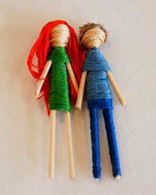 two dolls made out of yarn sitting next to each other