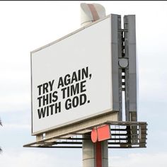 a large billboard with the words try again, this time with god