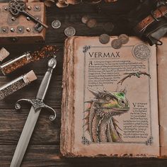 an open book sitting on top of a wooden table next to other items and coins