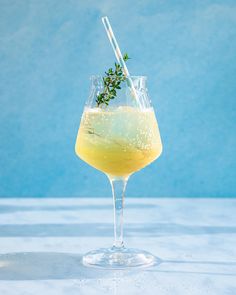 a glass filled with lemonade and garnished with a sprig of rosemary