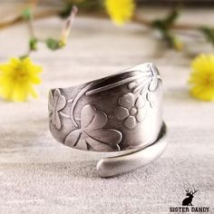 A beautifully detailed and handmade ring displaying clover leaves and blossoms made from an antique spoon. Shamrocks and clovers, particularly the three-leaf variety, are iconic symbols of Ireland, representing faith, hope, and love, with the rare four-leaf clover adding luck to the mix. These green, leafy plants have deep roots in Irish folklore and are celebrated worldwide on St. Patrick's Day, embodying a sense of heritage, fortune, and the lush landscapes of the Emerald Isle. A beautiful pie Celtic Clover, Clover Leaves, Vintage Spoon Rings, Irish Folklore, Irish Clover, Antique Spoons, Clover Ring, Celtic Ring, Iconic Symbols