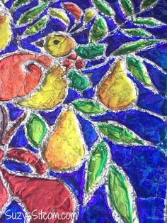 an art project made out of stained glass with fruit and leaves on the bottom layer