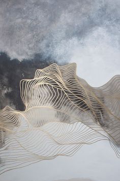 an abstract painting with wavy lines in gold and grey colors on a white background,