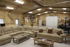 the inside of a garage with couches, tables and other things in it on display