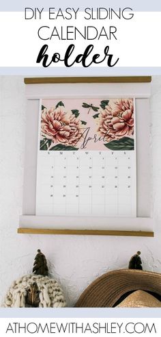 a calendar hanging on the wall with text overlay that reads diy easy sliding calendar holder