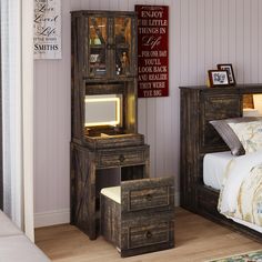 a bedroom with a bed, night stand and desk in front of a wall mounted sign