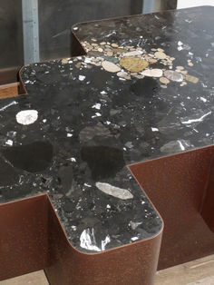 the counter top is covered in black marble and has holes to cut it into pieces